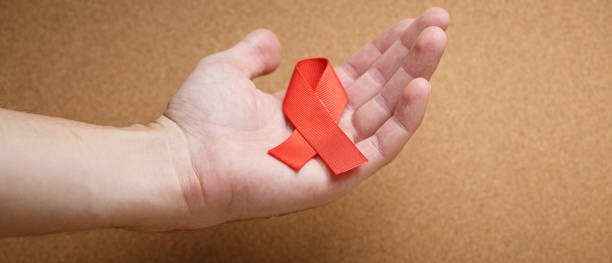 istock red AID ribbon on the cork table 1287602946