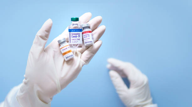Potential vaccines for Covid-19 during medical test in scientist's hands. Close-up of potential vaccines vials for Covid-19 for medical test in scientist's hands during research and development in laboratory. food and drug administration stock pictures, royalty-free photos & images