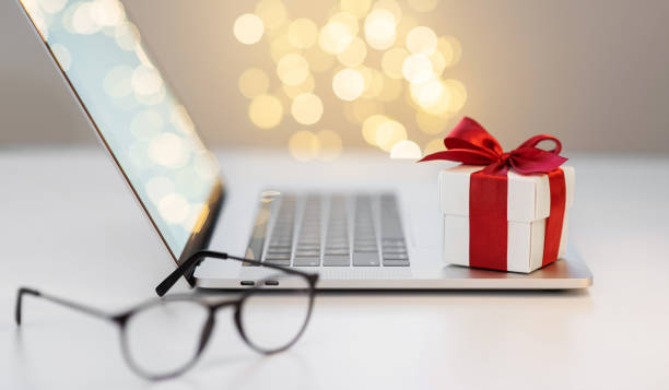 istock Gift on laptop at office desk, holidays, celebration concept 1287606712