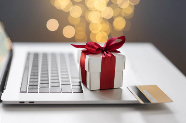 Online shopping during holidays. Christmas gift and credit card on laptop Ordering Christmas presents, online payment. Online shopping, internet banking, spending money, holidays, vacations concept holiday shopping stock pictures, royalty-free photos & images