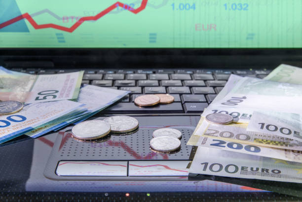 Money on the computer, franc, euro, cents. The concept of investment, exchange rate.