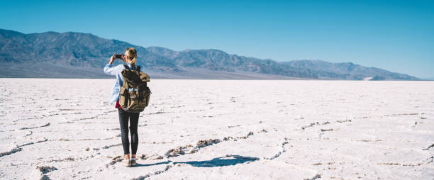istock Unrecognizable female hiker taking photo dry valley 1287608688