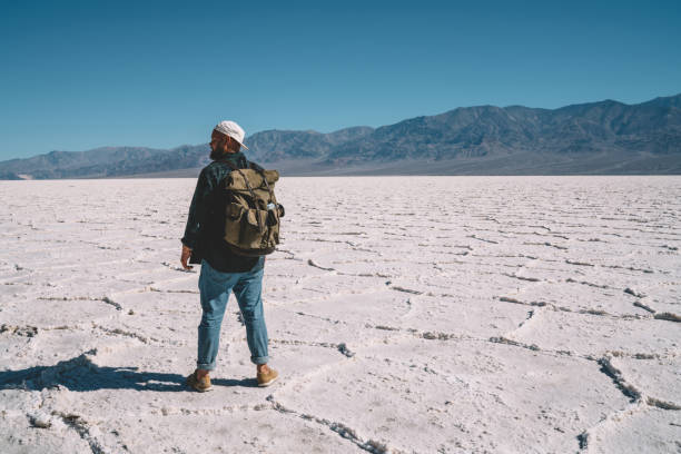 istock Unrecognizable traveler standing on frozen lake 1287608697