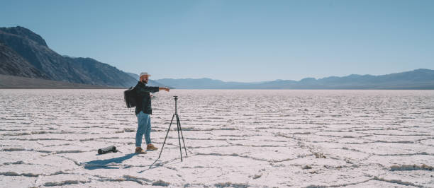 istock Male traveler configuring drone among cold valley 1287608700