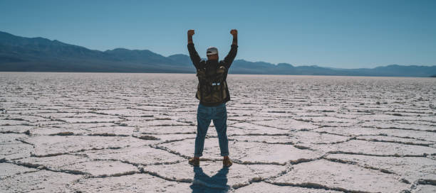 istock Faceless man standing in death valley 1287608711