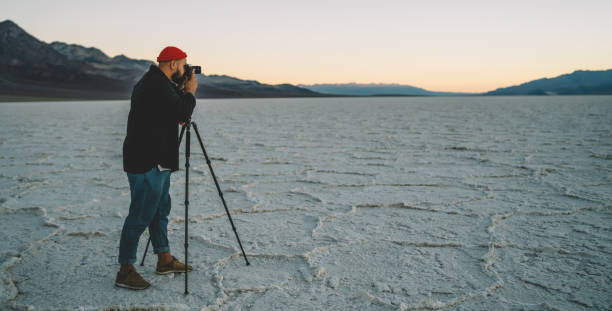 istock Anonymous traveler shooting nature at sunset 1287608721
