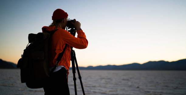 istock Unrecognizable female backpacker shooting mountains during sunset 1287608740