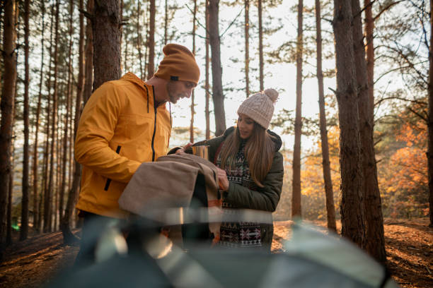 Happy couple camping and spending weekend together in nature