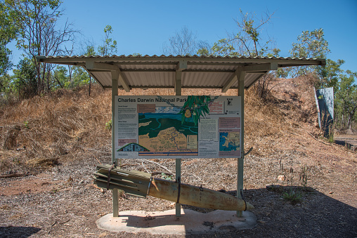 Darwin, NT, Australia-August 15,2018: WWII ammunitions bunker with land covering and sign with inert bomb at the Charles Darwin National Park in Darwin, Australia