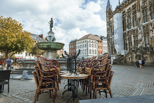 closed street cafe on market square in Aachen at summer day