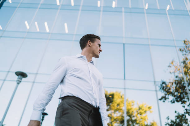istock Serious businessman walking down street 1287610883