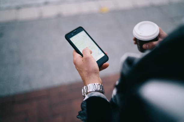 istock Unrecognizable man browsing smartphone in street 1287610902