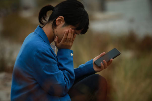 A woman crying with her smartphone in her hand