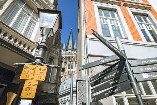 view on Cathedral in Aachen through small alley at sunny day