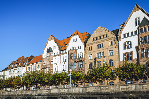 old residential houses at the rhine river side in Düsseldorf under blue sky