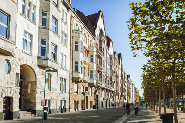 old residential houses at the rhine river promenade in Düsseldorf old residential houses at the rhine river side in Düsseldorf under blue sky düsseldorf stock pictures, royalty-free photos & images