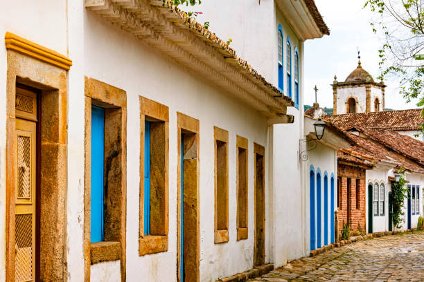 istock Old houses facades in colonial architecture and cobblestone streets 1287613968