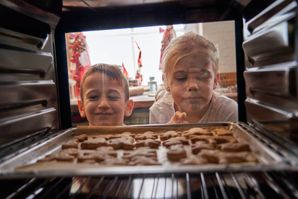 istock Little Kids Preparing Gingerbread Cookies in Domestic Kitchen 1287615112