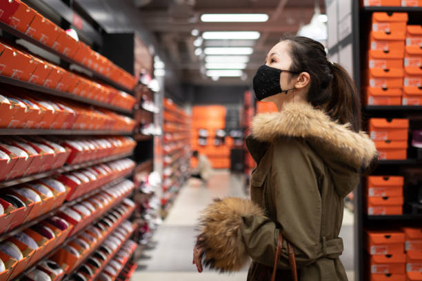 istock Woman shopping wearing a mask 1287615223