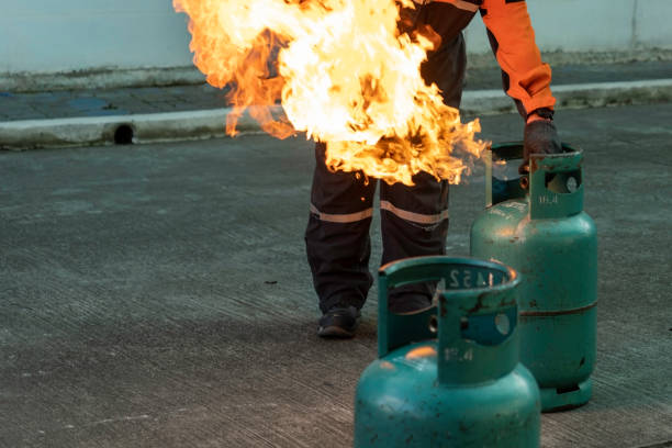 istock Man teaches how to use carbon dioxide  (CO2) fire extinguishers to extinguish fires from LPG cooking gas tanks. 1287615461
