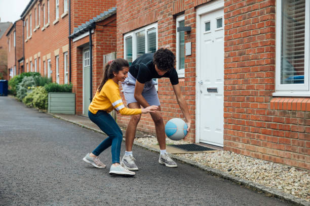 istock Brother And Sister Playing On The Driveway 1287616596