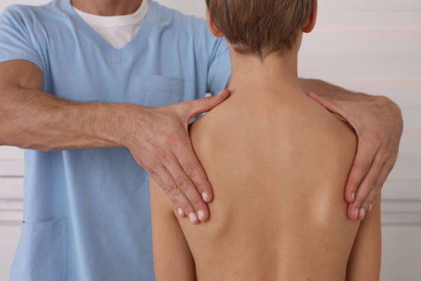 Physiotherapist exam for teenage boy. Manual Muscles Tests and Posture Checking . Preventive Health Care Visits in Children Posture correction. Scoliosis, Kyphosis treatment. Woman wearing posture posture corrector belt kyphosis stock pictures, royalty-free photos & images