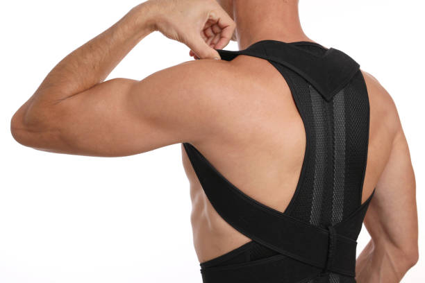 istock Posture correction. Scoliosis, Kyphosis treatment. Manwearing posture posture corrector belt 1287616956