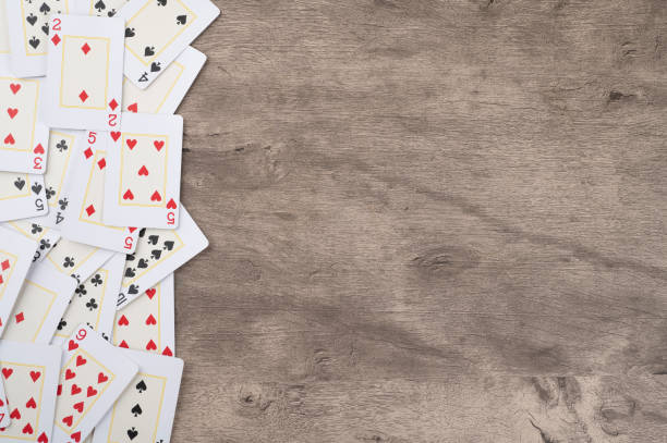 istock Playing cards over wooden background with copy space 1287619749