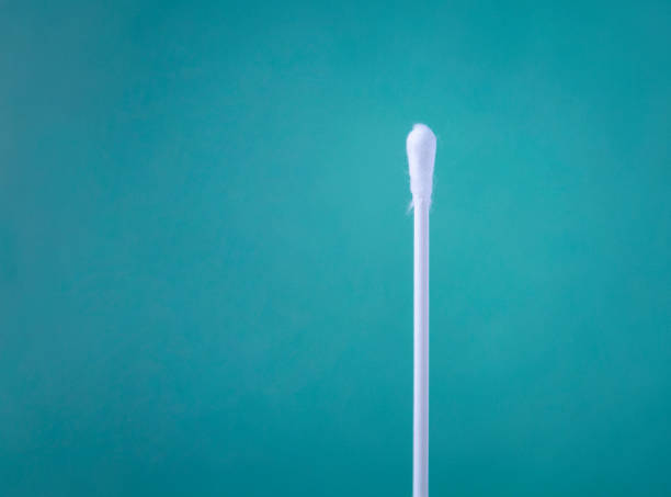 Covid-19 test Cotton stick close-up over turquoise background with copy space. cotton swab photos stock pictures, royalty-free photos & images