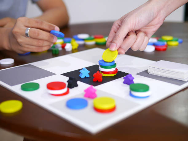 istock people playing fun board game on wooden table top selected focus 1287621199