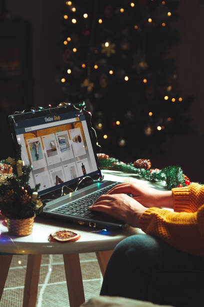 istock young woman with laptop over christmas tree background 1287621323