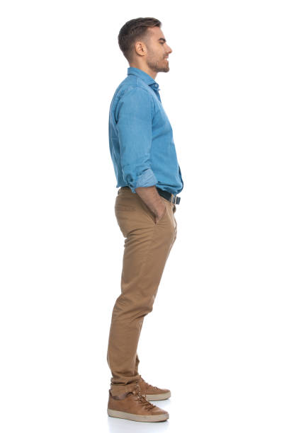 istock casual young man standing with his hands in his pockets 1287622917