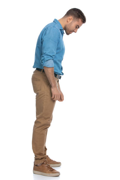 istock sexy casual man looking down at something 1287623476