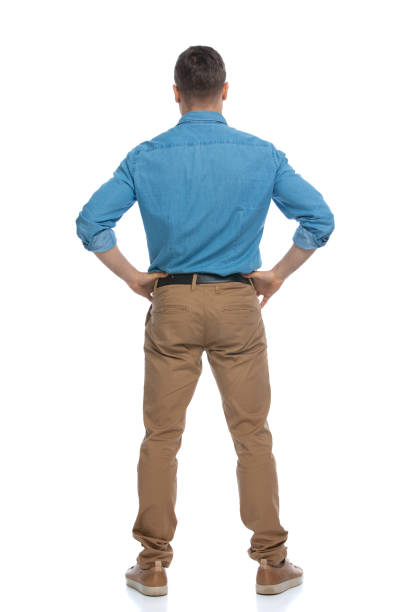 istock casual man standing with his hands on his hips 1287623564