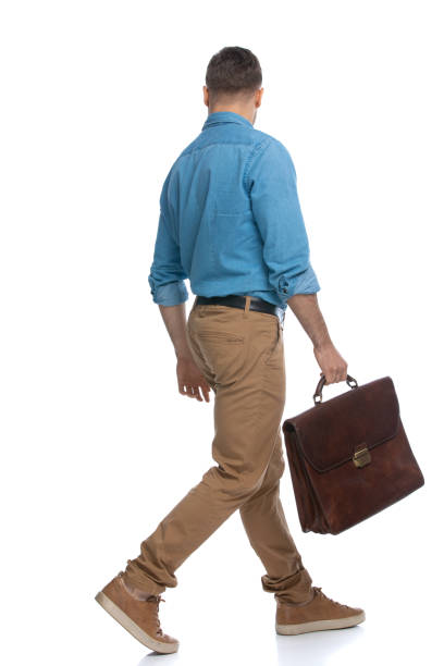 istock casual guy walking one way and looking the other 1287624084