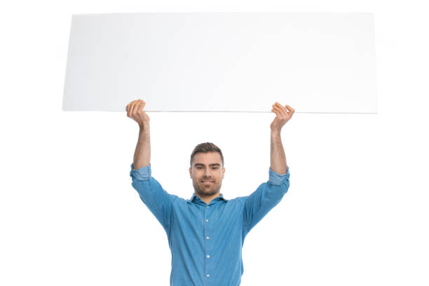 istock handsome casual man holding a wide billboard overhead 1287624755