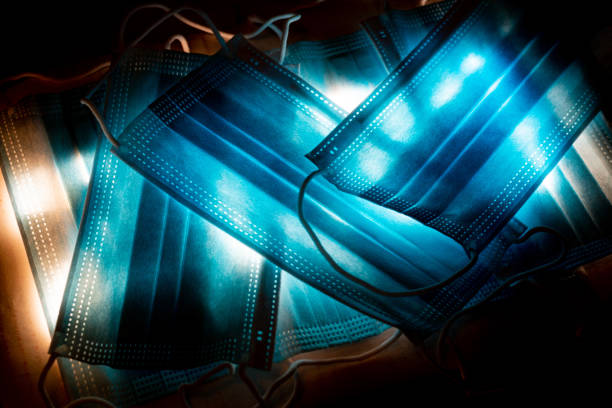 istock Several medical masks with glowing light. Coronavirus protection concept. 1287625689