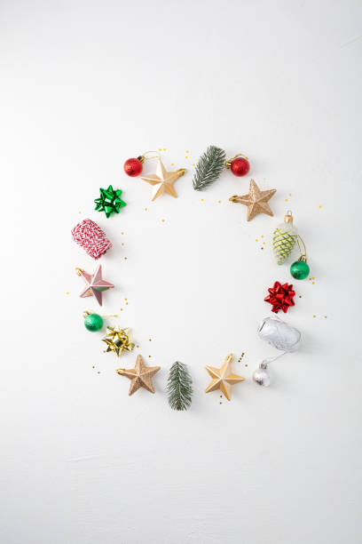 istock Christmas circle decor composition. Wreath of decorations stars, eve, pine cone on white background 1287625895