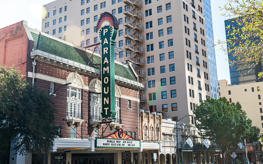 Austin , Texas , USA - November 2nd 2020: Historical Old Paramount Movie theater in Downtown Austin Texas with large skyscrapers built all around it