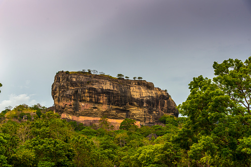 Spectacular view of the Sigiriya Lion rock surrounded by green rich vegetation. Picture taken from Pidurangala mountain in Dambula, Sri Lanka.