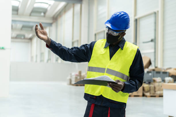 istock Logistic worker managing in warehouse wearing face mask 1287628005