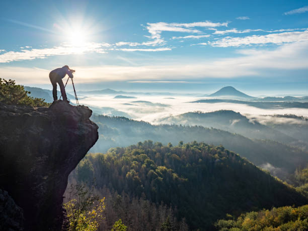 istock Photographer Framing Scene In Viewfinder. Man Is Using Camera On Tripod For Taking Pictures Of Land 1287628995