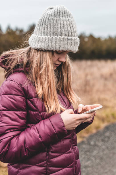 istock Cute girl chatting via smartphone 1287629239