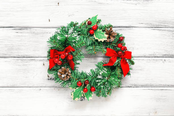 istock Christmas wreath on an old white wooden background. Minimal Christmas composition. 1287629281