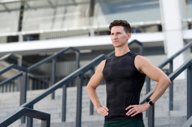 istock Man muscular shoulders motivated for workout urban background 1287629607