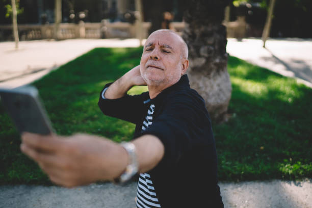 istock Joyful senior man taking selfie in park 1287630682
