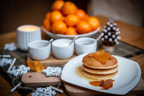 istock Festive table setting with vegan pancakes and tangerines 1287630771