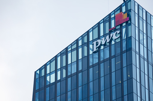 Vienna, Austria - July 31: Logo of PricewaterhouseCoopers (PwC) on glass facade of building of the DC Tower 1(it the tallest skyscraper in Austria) in Vienna Donau city in Vienna, on July 31, 2019.