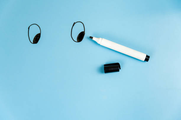 istock Drawn smiley eyes and a marker for drawing beside. 1287633074