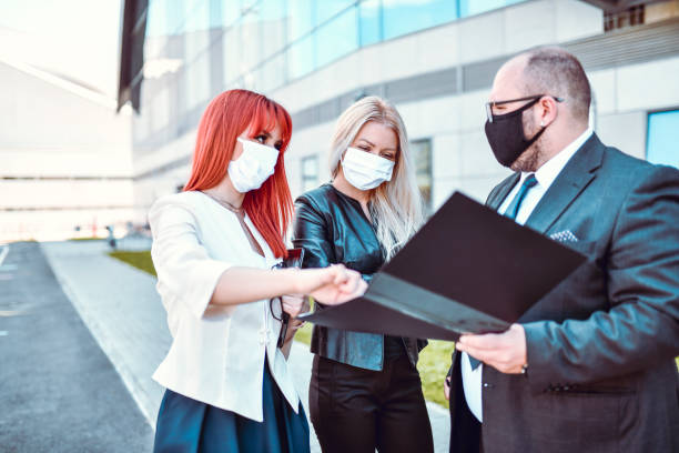 istock CEO Discussing New Business Strategy With Female Employees With Face Masks 1287636321